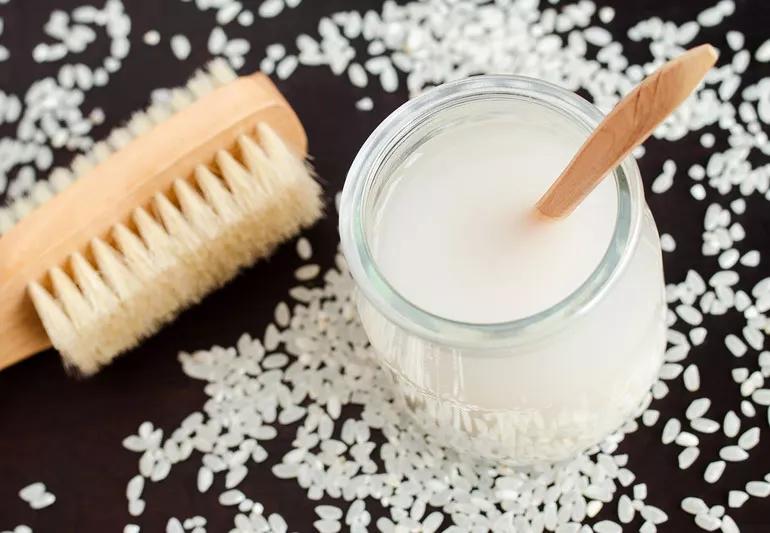 jar of rice water and brush for hair