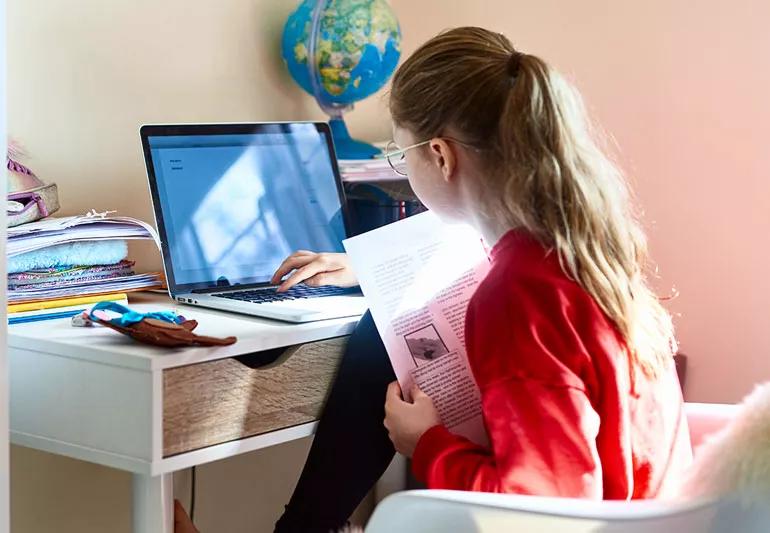 Teen studies at student desk