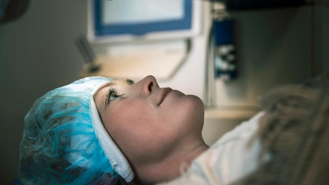 Patient lying on medical table awaiting an eye procedure