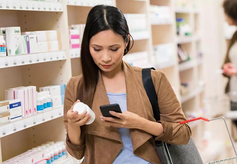 Person shopping for a vitamin supplement.