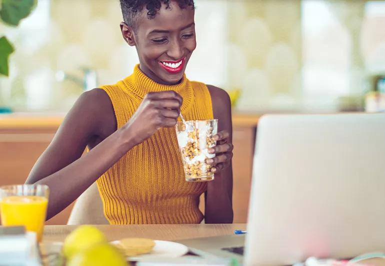 woman eating yogurt parfait for health benefits