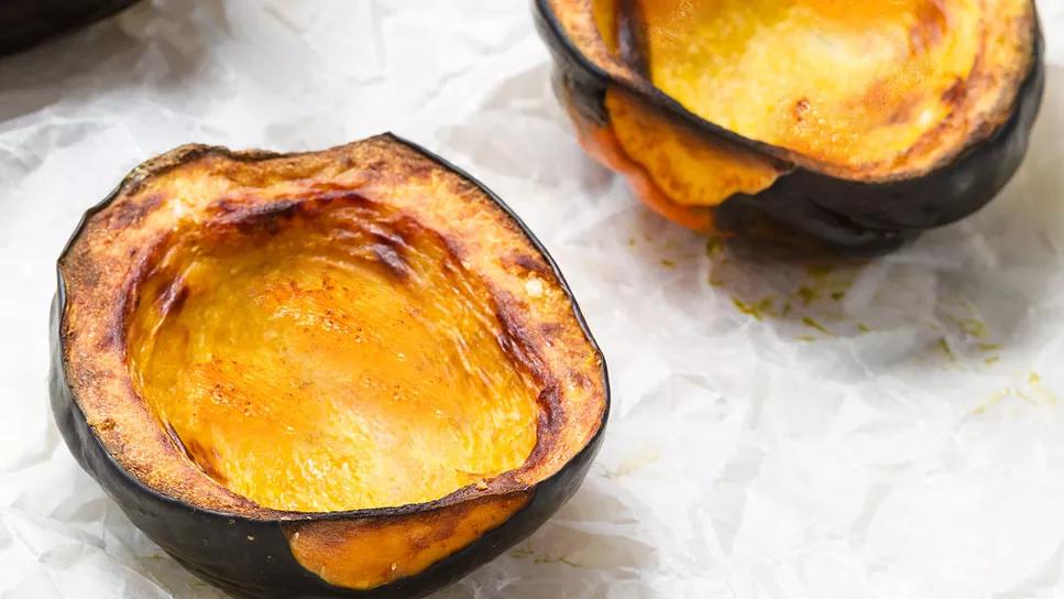 Hot cinnamon baked acorn squash on parchment paper