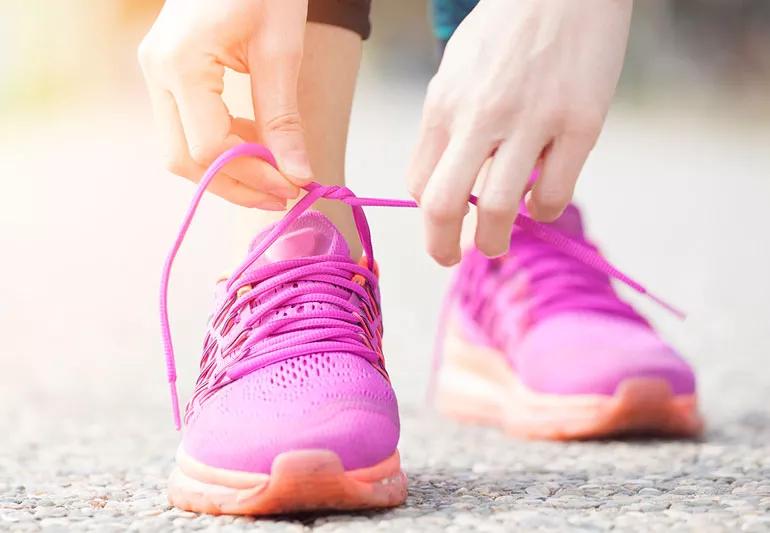 Woman putting on her new walking shoes