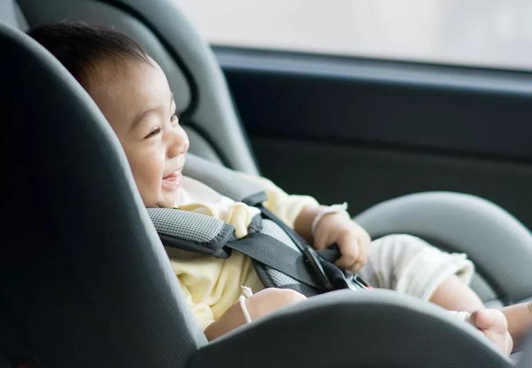 happy baby in car seat