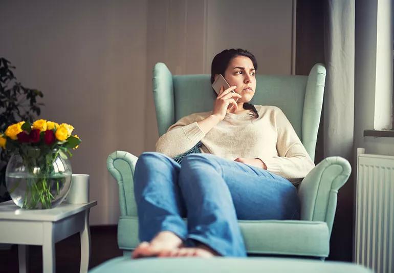 anxious girl on the phone calling someone who is ghosting her