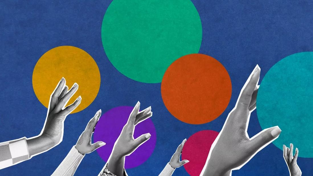 women's hands reaching for colorful circles