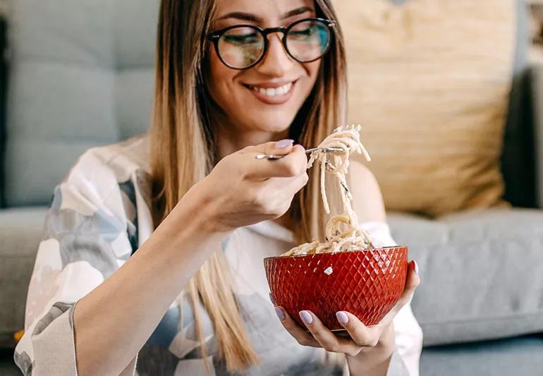 Woman eating noodles gluten celiac disease