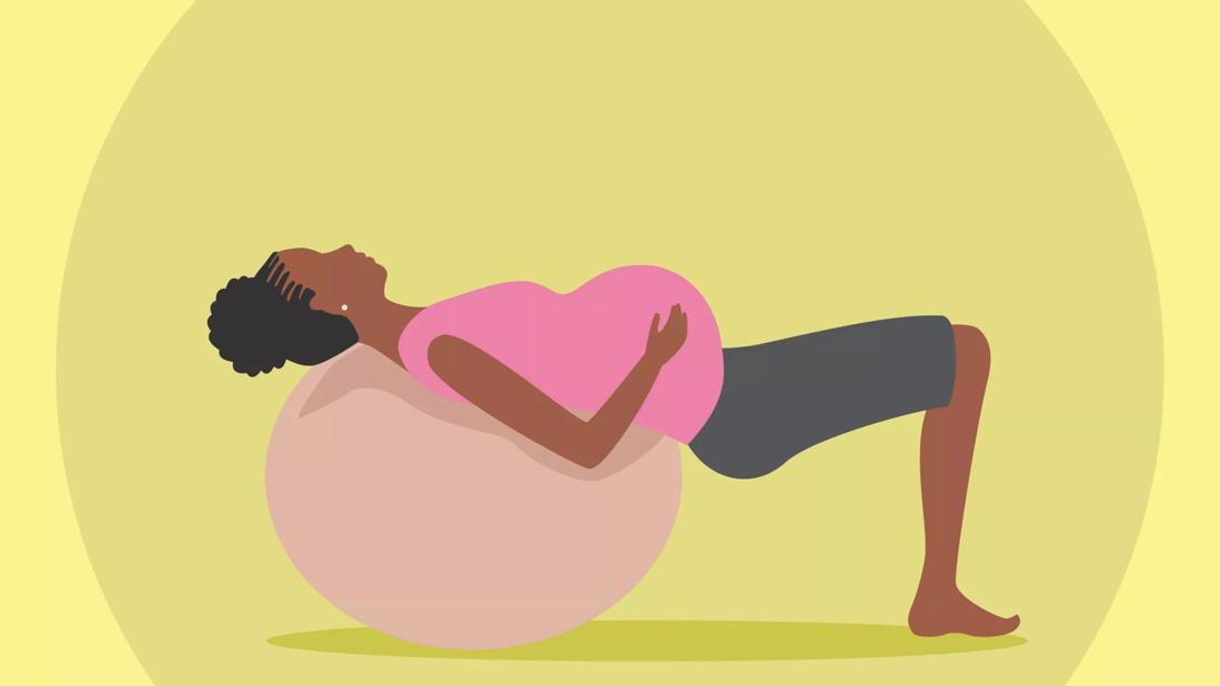 woman laying on birthing ball for exercise
