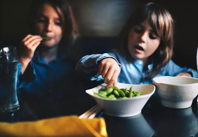 Family snacking on edamame