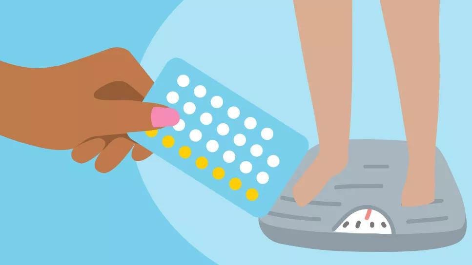 Hand holding packet of birth control pills in front of feet on a scale