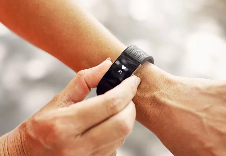 Woman checking her heart with her fitness tracker