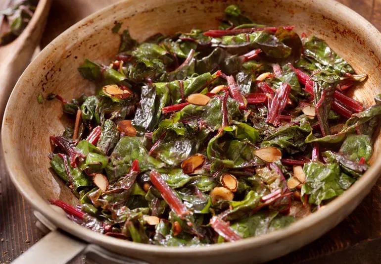 Bowl of Sauteed swiss chard with almonds