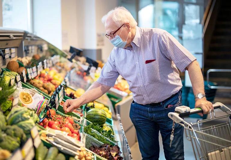 man shopping with protective mask on face