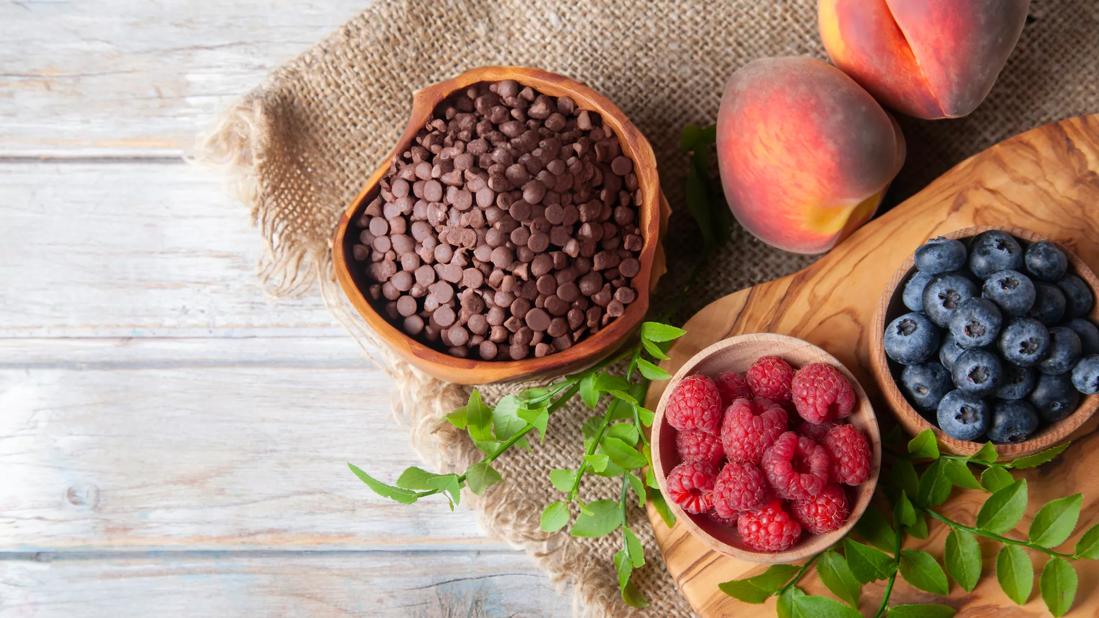 Raspberries, blueberries, peaches and chocolate chips, with mint