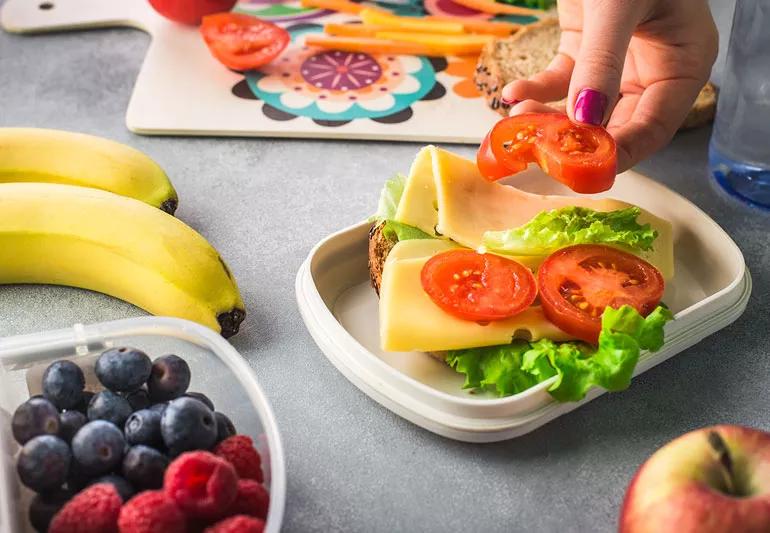 Parent preparing healthy lunch for their child.