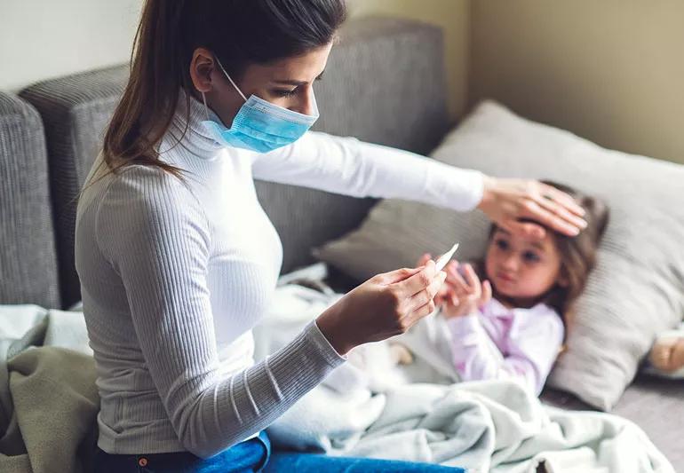 Woman taking her child's temperature.