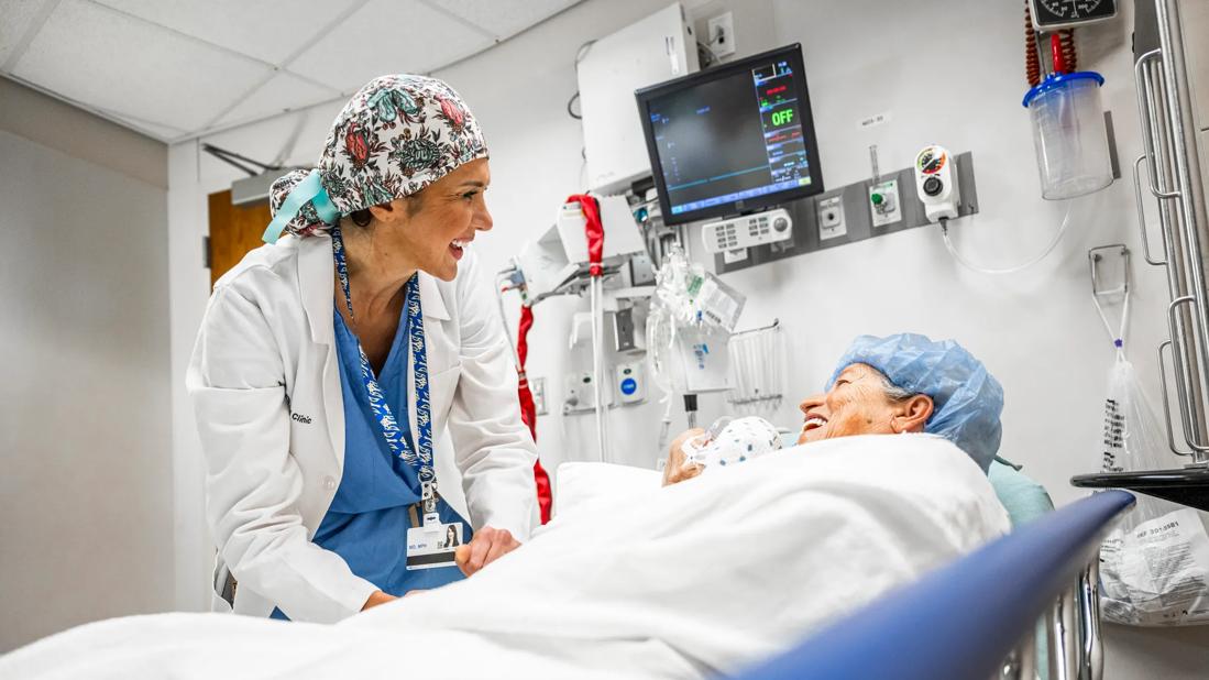 Physician smiles at patient in a preoperative setting