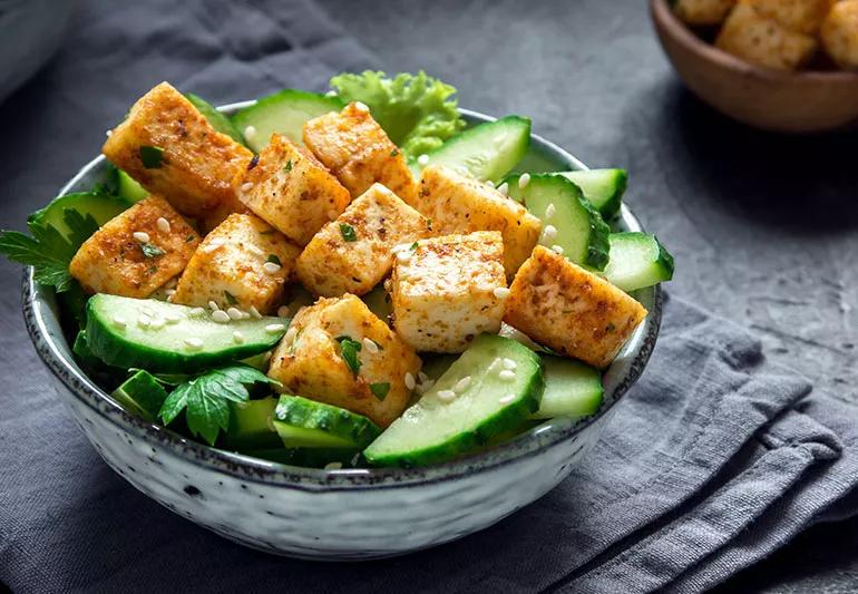 A bowl of grilled tofu and cucumber salad