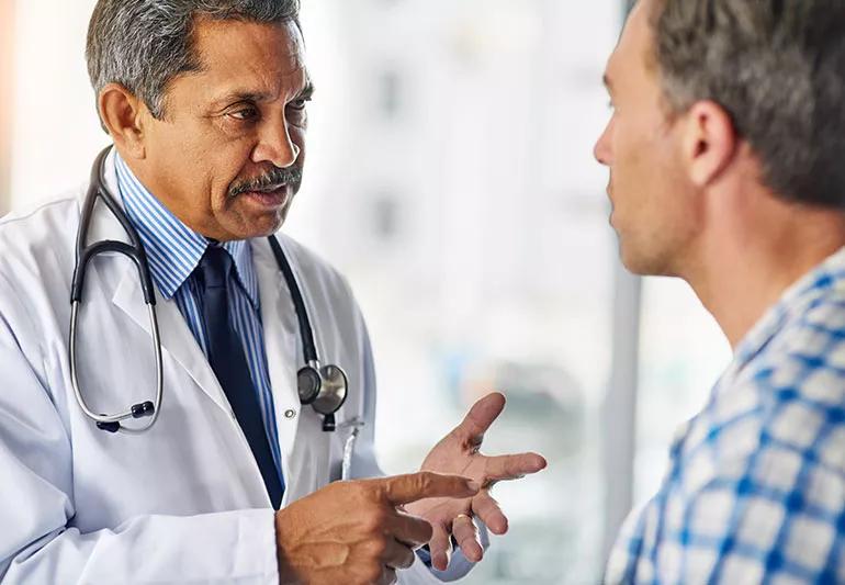 Physician discussing health issues with patient during appointment.