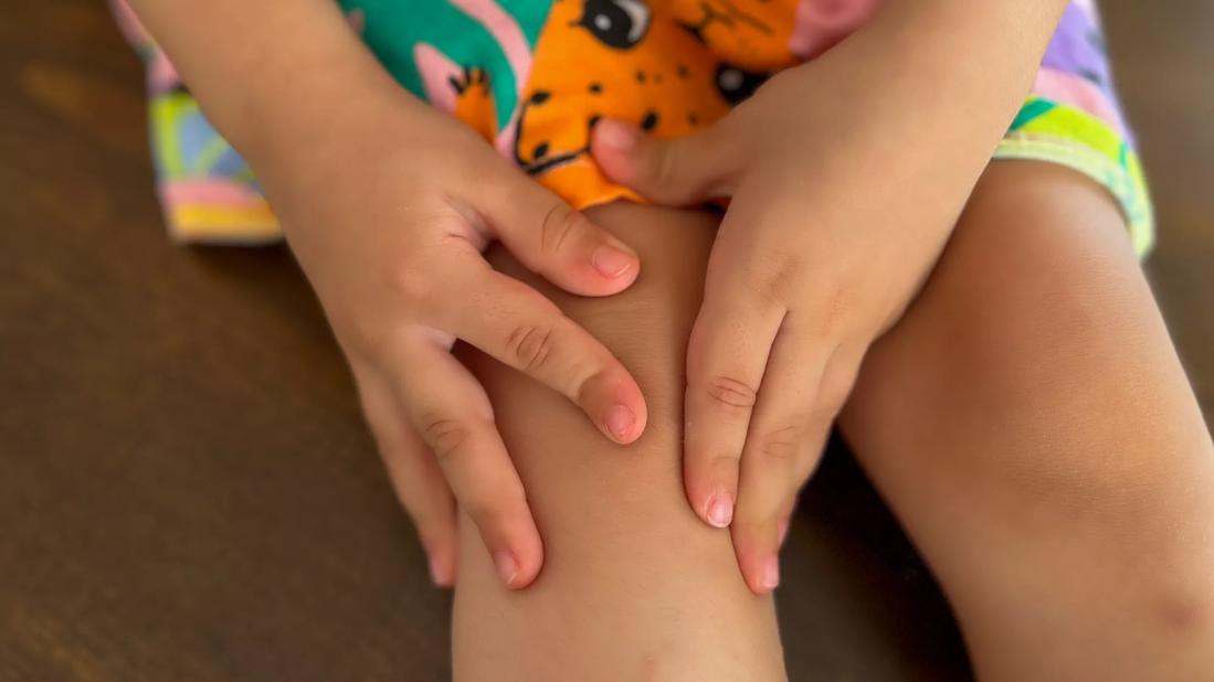 Child with hands on their knee