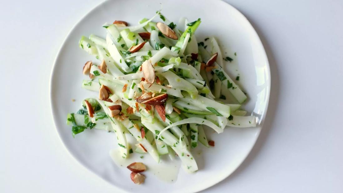 Crisp apple-fennel-mint salad with almonds on a plate