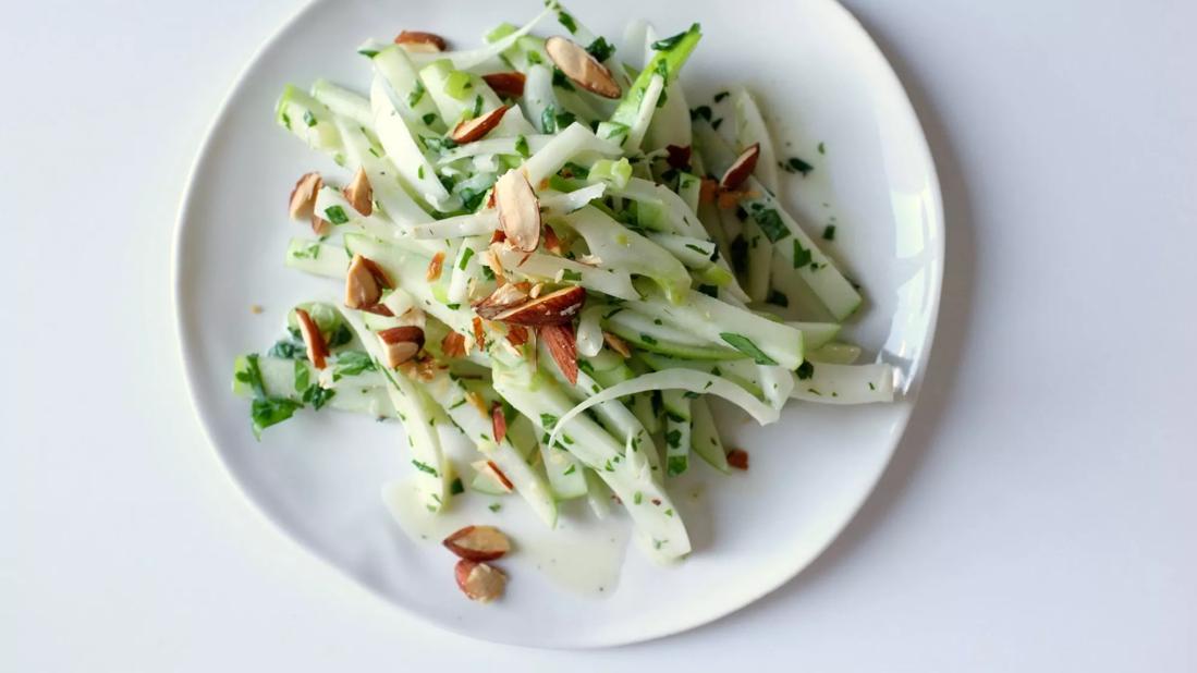 Crisp apple-fennel-mint salad with almonds on a plate