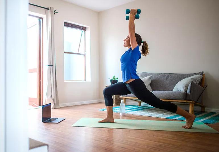 woman exercising at home yoga
