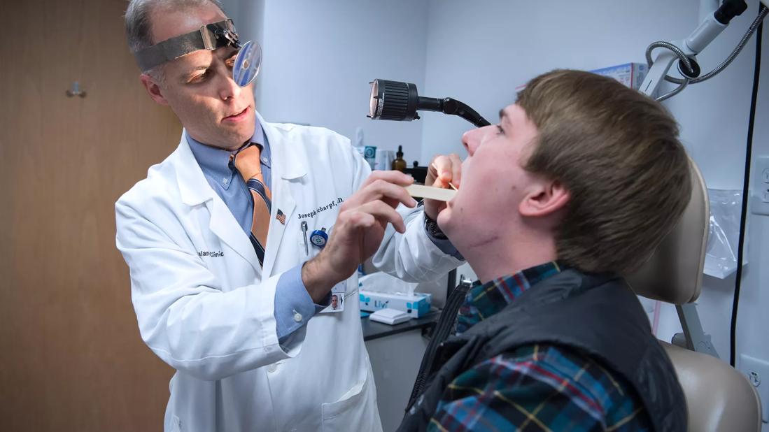 Doctor performing oral exam on patient