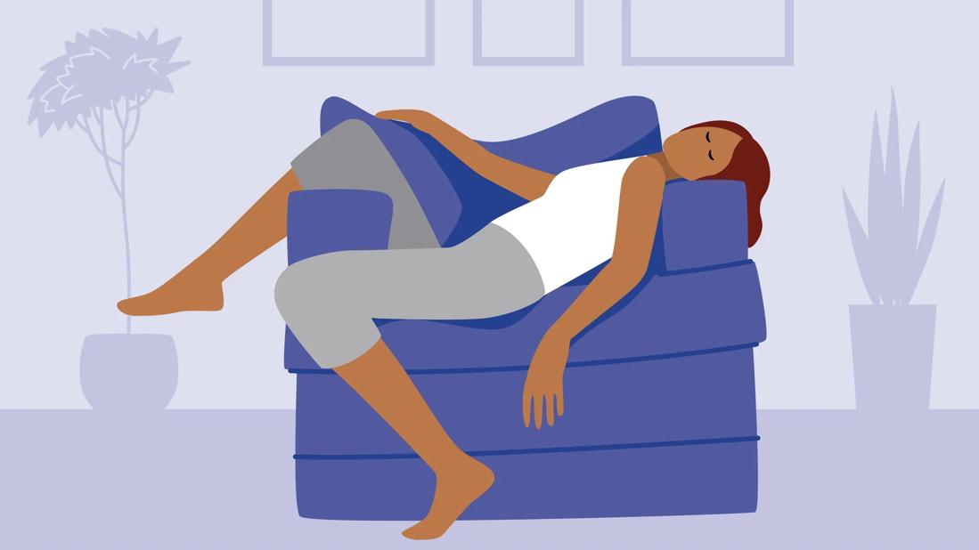 Person splayed across a comfy armchair asleep