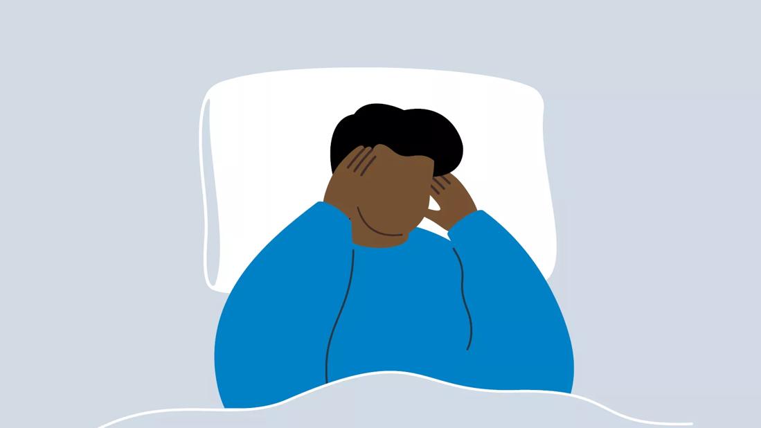 An illustration of a person laying in bed and holding their head in pain