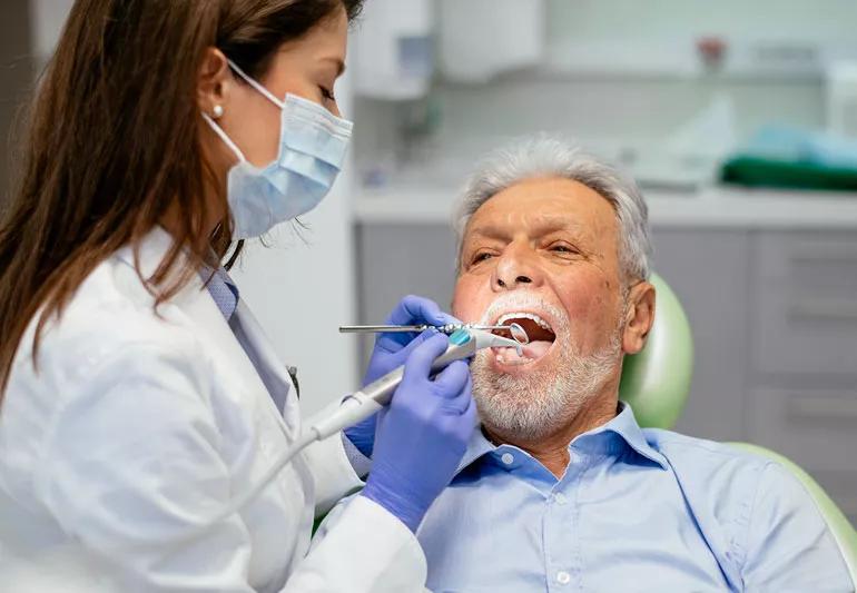 Elderly man having dental exam