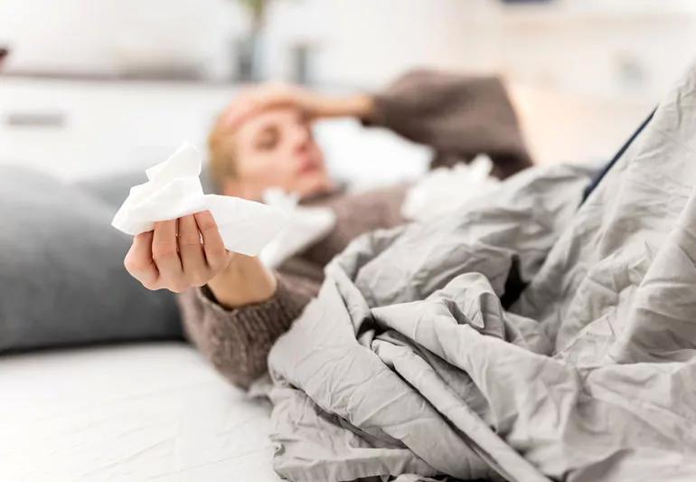 woman in bed wtih sinus problems