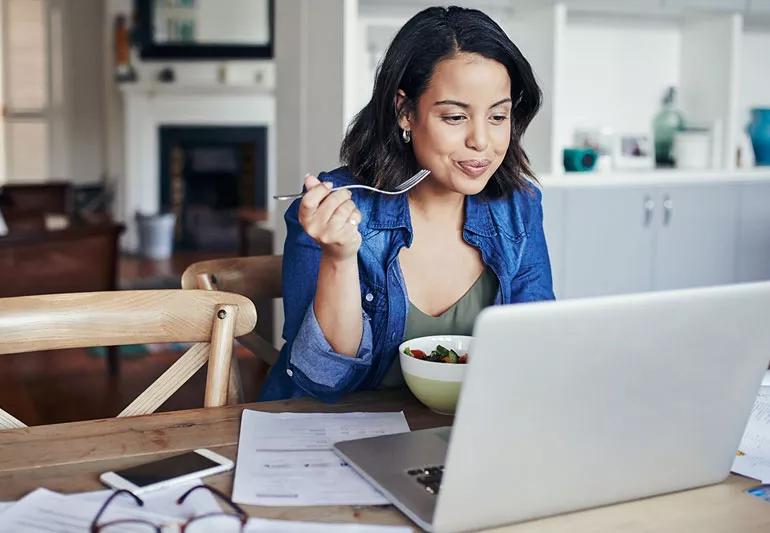 woman eats healthy while working from home