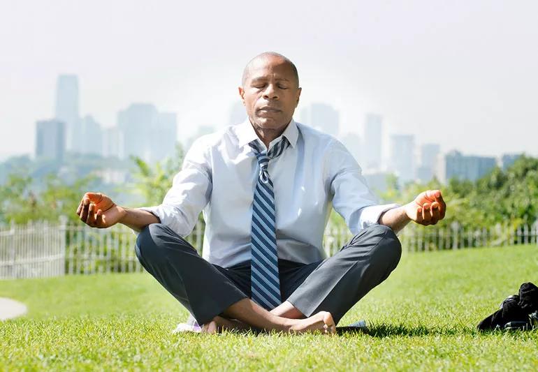 man meditating in the middle of a business day