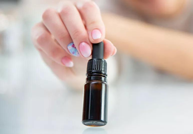 woman holds small bottle of liquid fulvic acid