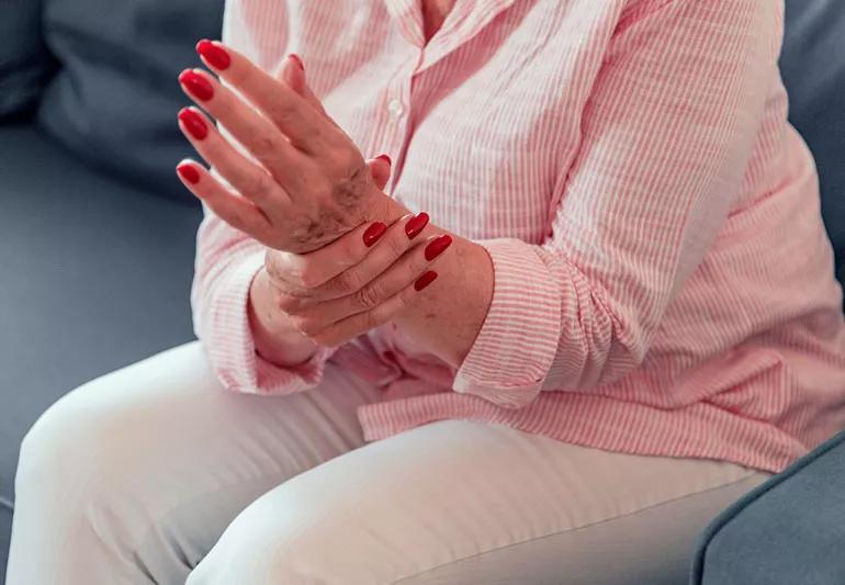 Elderly woman suffering from arthritic pain in her wrist