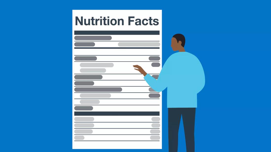 Person reading a nutrition label.