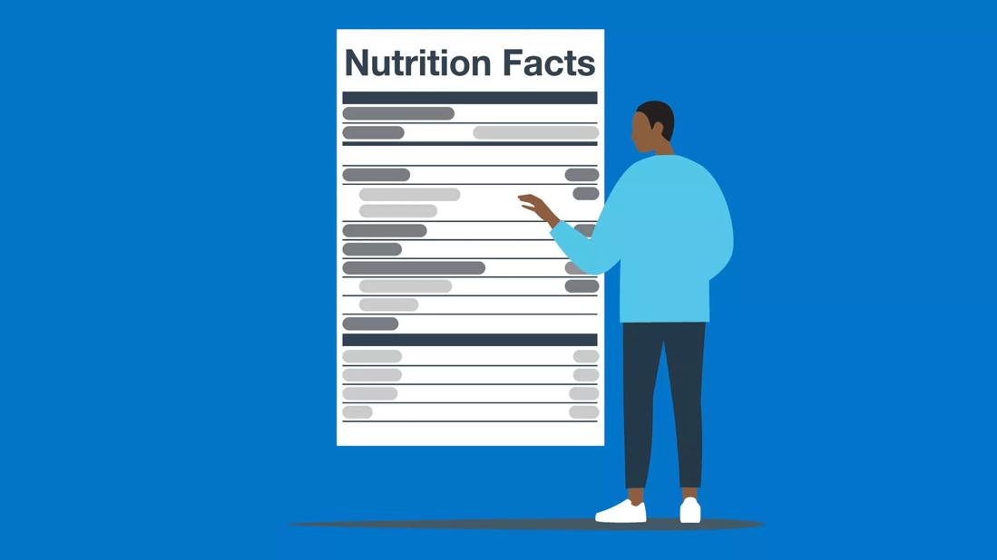 Person reading a nutrition label.