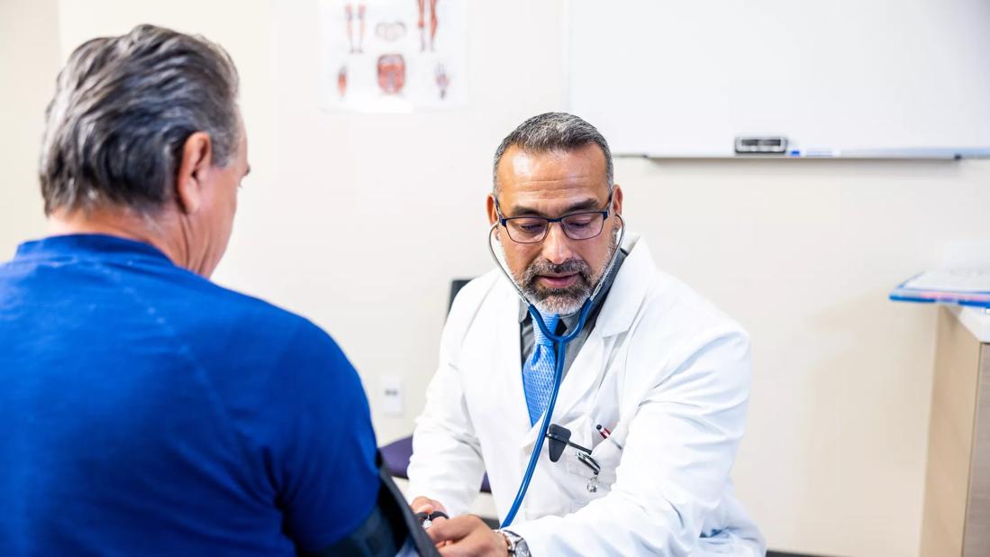 Physician taking patient's blood pressure