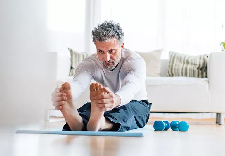 elderly man stretching out and lifting weights
