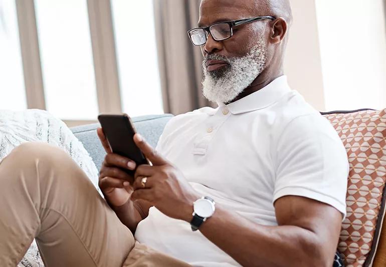 elderly man looking at smartphone