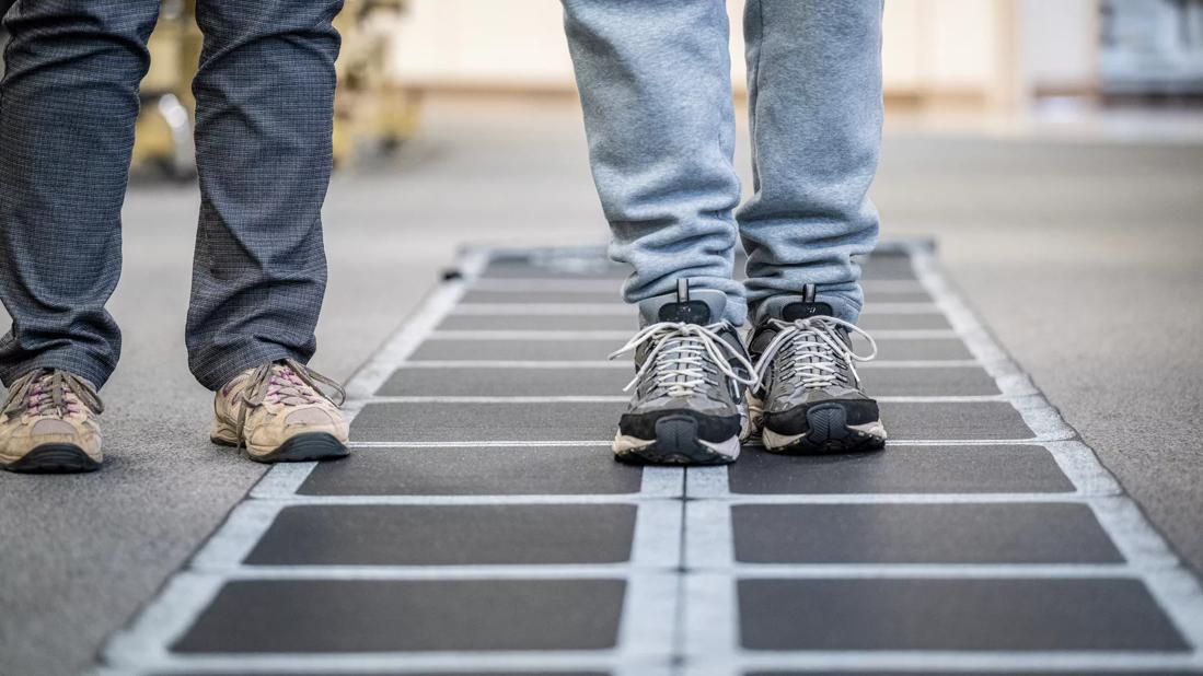 Legs of healthcare provider and patient during rehabilitation