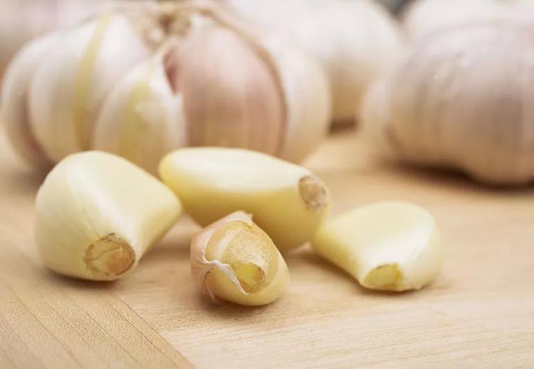 Bulbs of garlic on a cutting board.