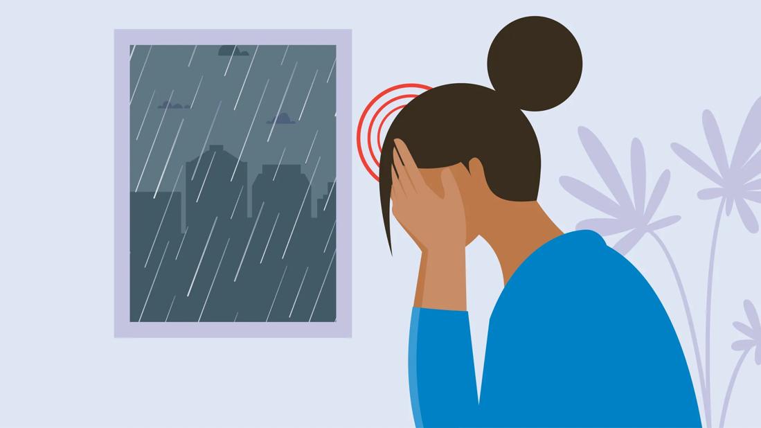 A person suffering from a headache during a storm.