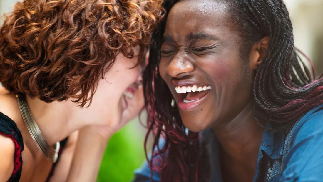 Two friends laughing together