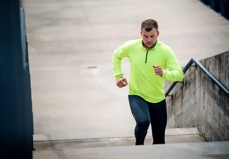 Man running up stairs for cardio workout