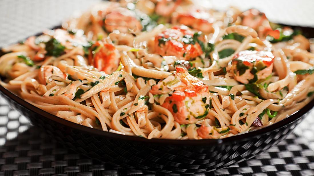 Bowl of seasoned Asian noodles with salmon