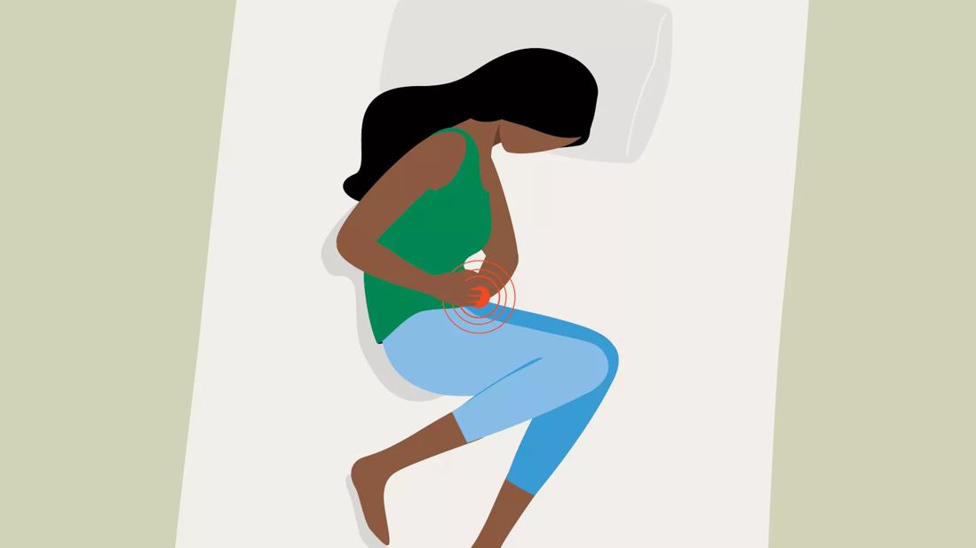 An illustration of a person lying in bed holding their stomach in pain