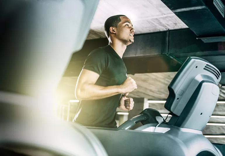 Man desperately running on treadmill