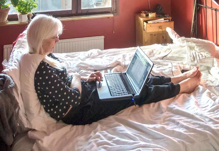 woman working from her bed